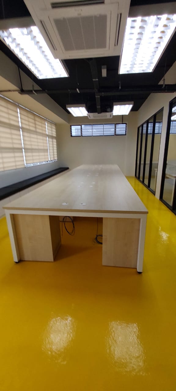 Bank Islam Cyberjaya fitted room with worktable, glass partitions, ceiling lighting and yellow flooring