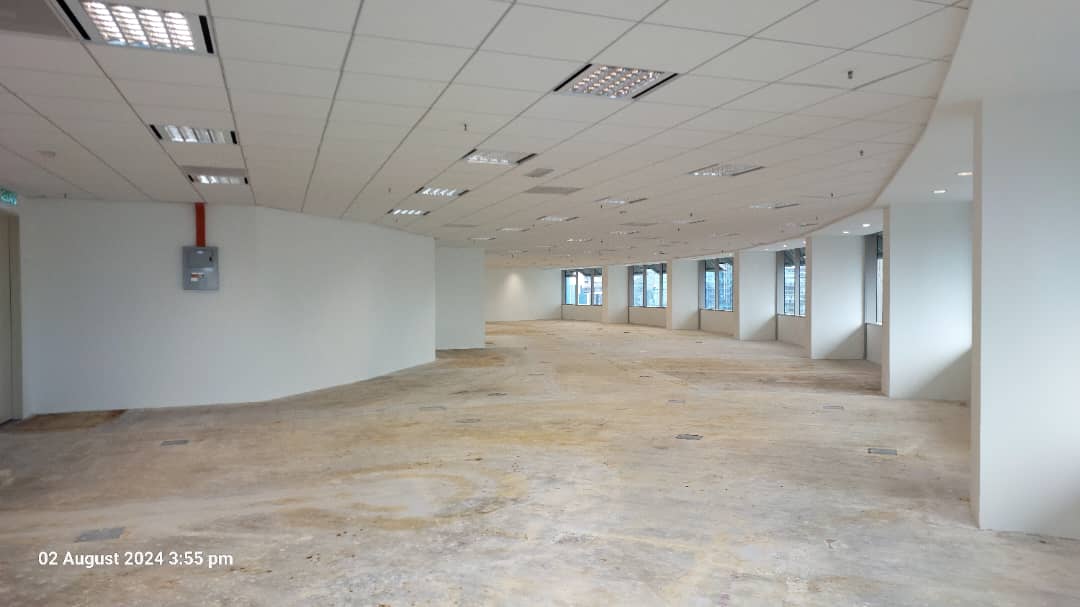 Level 33 Menara Maxis handover view showing the open reinstated office floor, white walls and ceiling lighting, photographed on 2 August 2024